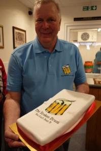 Andy Wheeler with cake to celebrate the grand opening